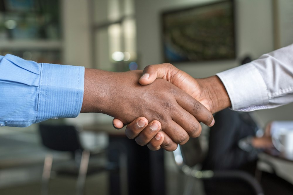 Partners shaking hands after successful law firm transformation